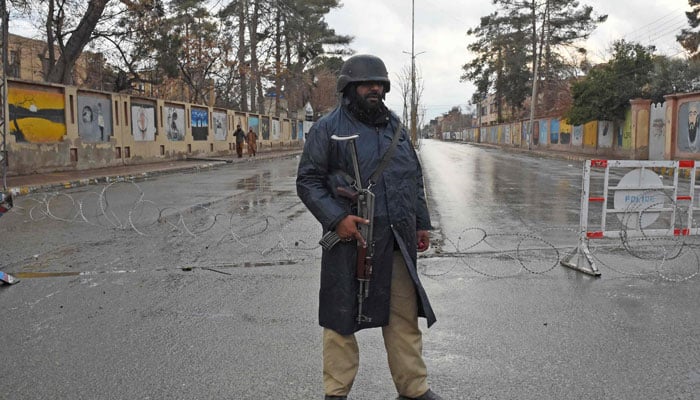 A policeman stands guard near a blast site after an attack by terrorists in Quetta on January 31, 2026. — AFP