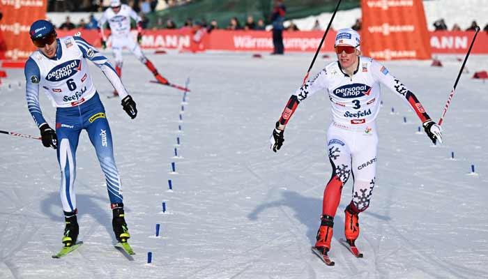 Finlands Ilkka Herola and Norways Einar Luraas Oftebro compete finish the Mens Individual Compact 7,5km event at the FIS Ski Nordic Combined World Cup, on January 31, 2026.— AFP