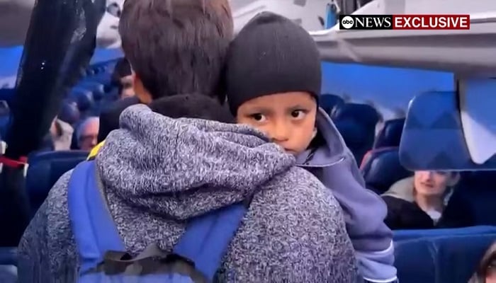 Liam Conejo Ramos is held by his father, Adrian Alexander Conejo Arias, while boarding an aircraft to return to Minneapolis, after the pair, who had been detained by immigration officers, were ordered released by a judge from a Texas detention centre, in San Antonio, Texas, US, February 1, 2026, in a still image from video. ABC News via REUTERS. — Reuters