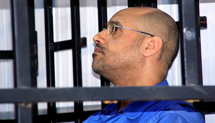 Saif al-Islam Gaddafi, son of late Libyan leader Muammar Gaddafi, attends a hearing behind bars in a courtroom in Zintan May 25, 2014. — Reuters