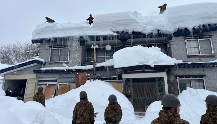Members of the Japan Ground Self-Defence Force´s 5th Infantry Regiment, stationed in Aomori Prefecture, carrying out snow removal work in a town within Aomori Prefecture on February 3, 2026. — AFP