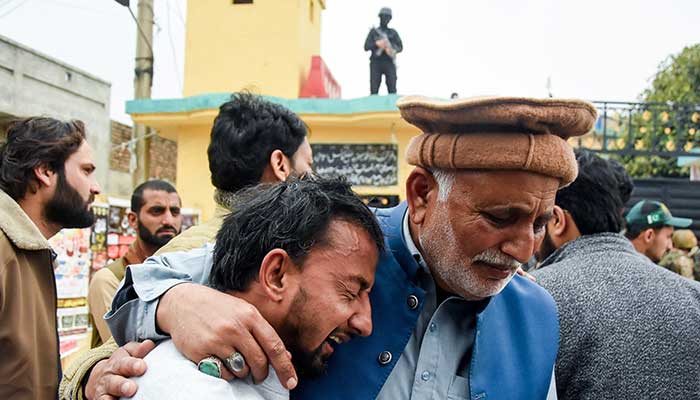 A man reacts while being comforted, after a deadly explosion at a mosque in Islamabad, February 6, 2026. — Reuters