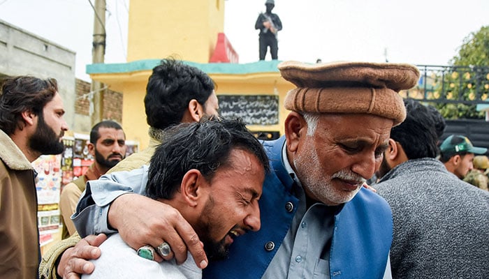 A man reacts while being comforted, after a deadly explosion at an imambargah in Islamabad on February 6, 2026. — Reuters