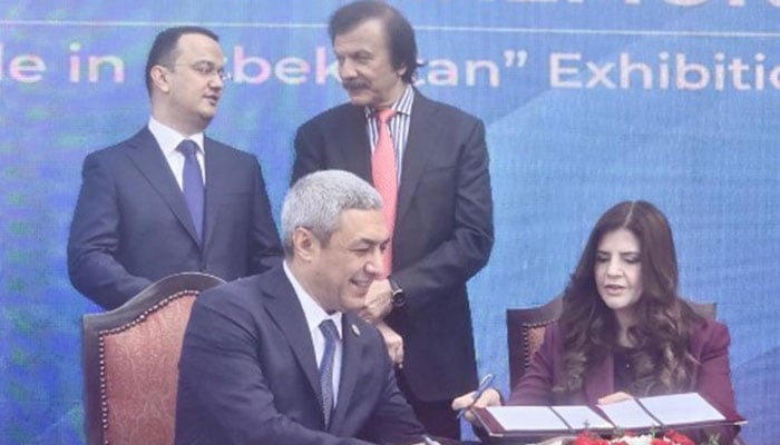 Uzbekistans of Agency for the Development of Light Industry Nozimjon Kholmurodov (left) exchanges MoU with Cotton House Founder and CEO Fouzia Atif. — Geo News