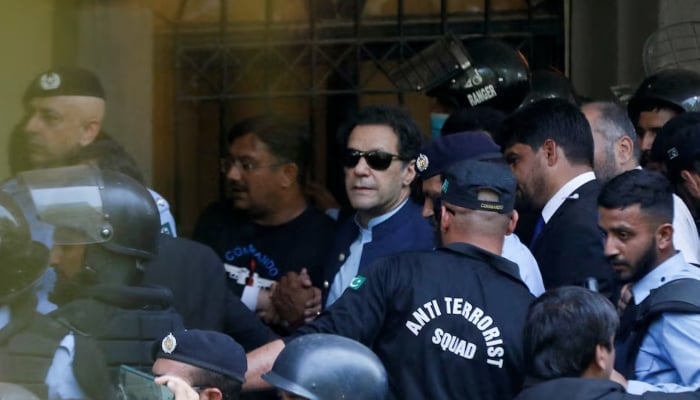 Security officers escort former prime minister Imran Khan, as he appeared in Islamabad High Court, Islamabad, May 12, 2023. — Reuters