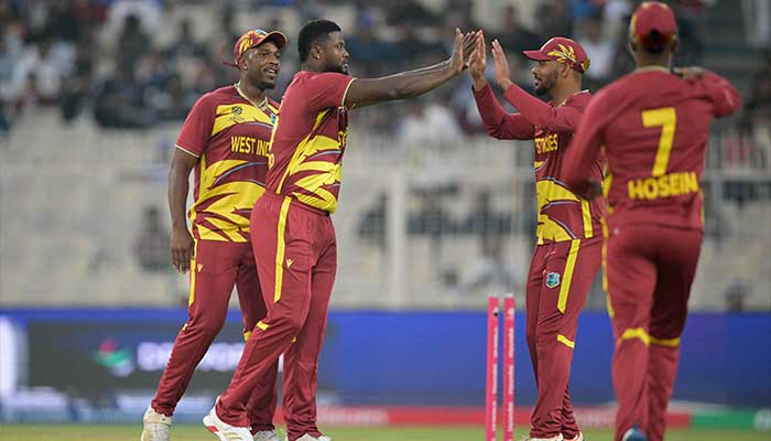 West Indies Romario Shepherd celebrates with teammates after taking the wicket of Scotlands Brandon McMullen during the 2026 ICC Mens T20 Cricket World Cup group stage match between Scotland and West Indies at the Eden Gardens in Kolkata on February 7, 2026. — AFP