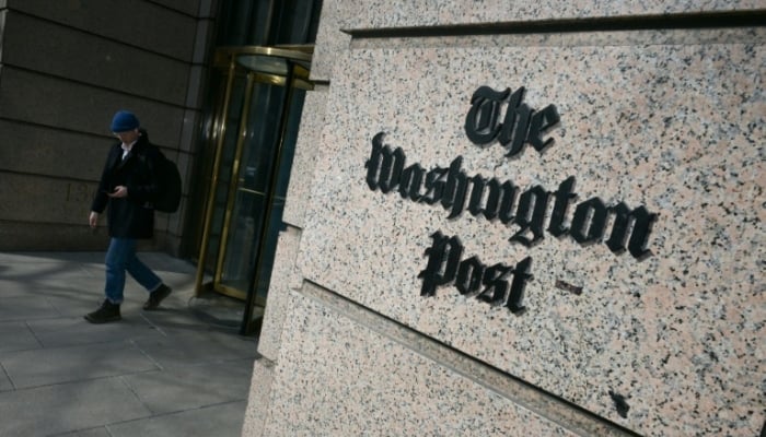 A man exits the Washington Post office building in Washington, DC, on February 4, 2026. — AFP