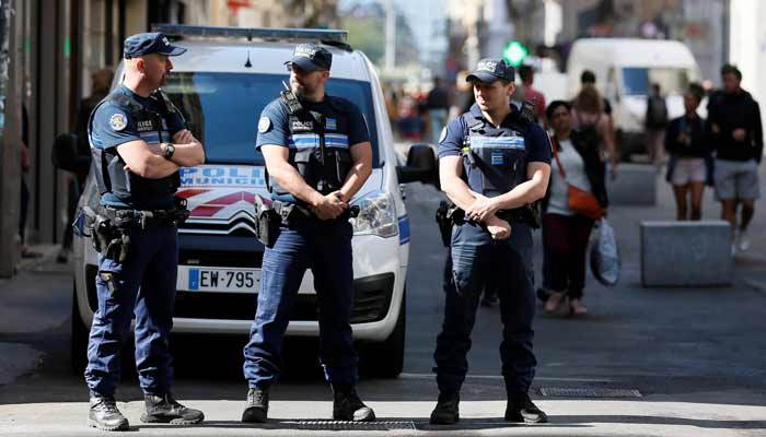 Police patrol the streets during the manhunt of a suspected suitcase bomber in central Lyon, France.— Reuters/File