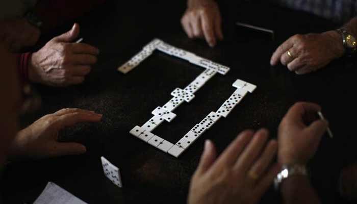 Pensioners play dominoes at a seniors centre during the International Day of Older Persons in Ronda, near Malaga. — Reuters/File