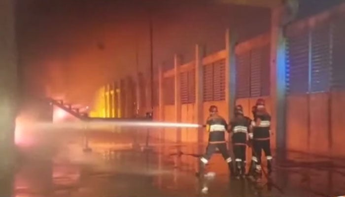 The image shows firefighters busy with operation to extinguish the fire at Rawat factory on February 10, 2026. — Geo News/Screengrab