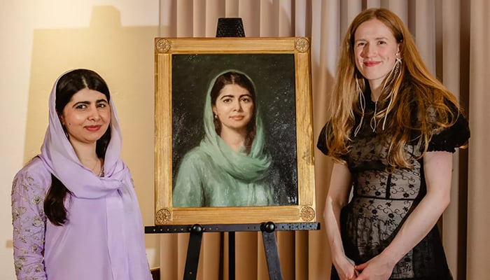 Nobel Peace Prize laureate Malala Yousafzai (left) with artist Isabella Watling at her portrait unveiling ceremony at Oxford University’s Lady Margaret Hall, London. — Reporter