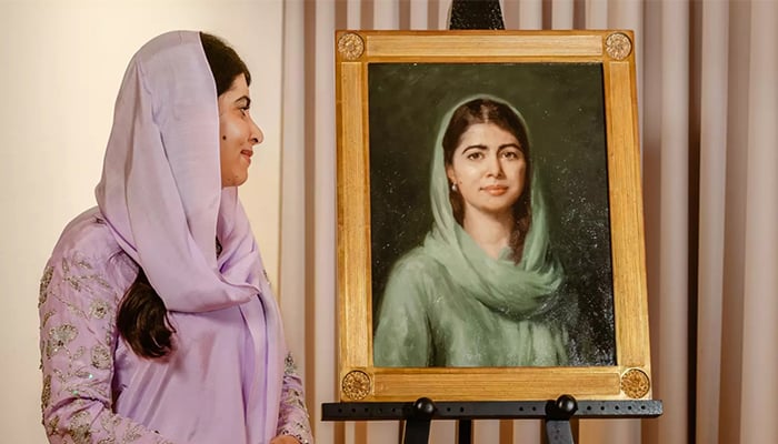 Nobel Peace Prize laureate Malala Yousafzai looks at her portrait, painted by artist Isabella Watling, and unveiled at Oxford University’s Lady Margaret Hall, London. — Reporter