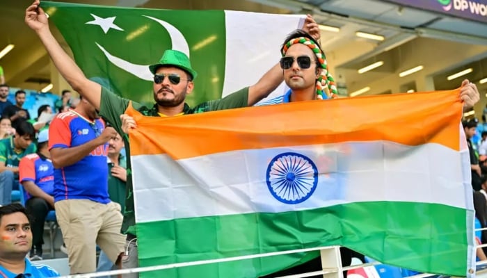 Pakistan and India cricket fans displaay their flags at a match. — AFP