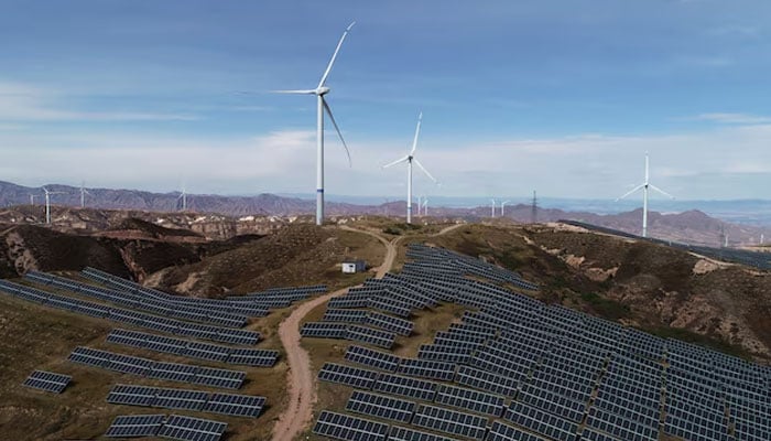 Wind turbines and solar panels are seen at a wind and solar power plant by State Power Investment Corporation (SPIC) in Zhangjiakou, Hebei province, China on October 29, 2018. — Reuters
