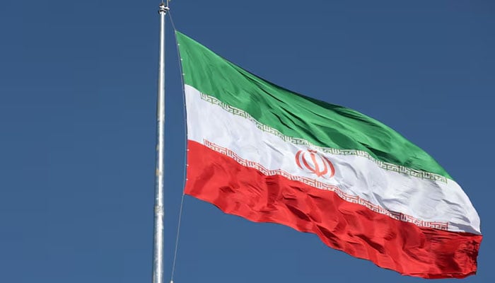 The Iranian flag is seen flying over a street in Tehran, Iran, February 3, 2023. — Reuters