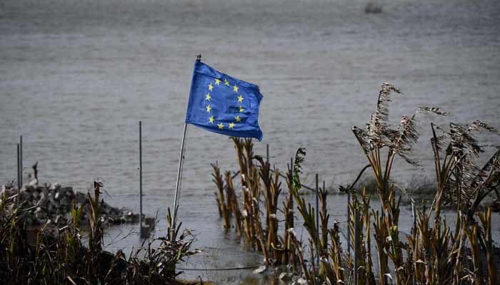 A European flag flies next to a flooded field at Las Pachecas settlement in Jerez, southern Spain, on February 5, 2026, amid Storm Leonardo. — AFP