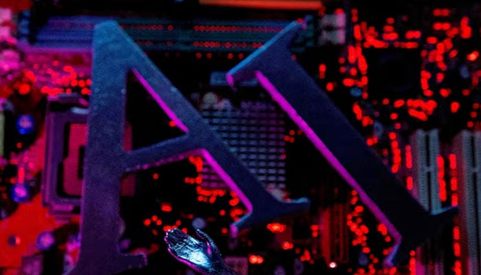 AI (Artificial Intelligence) letters and robot hand are placed on computer motherboard in this illustration created on June 23, 2023. — Reuters