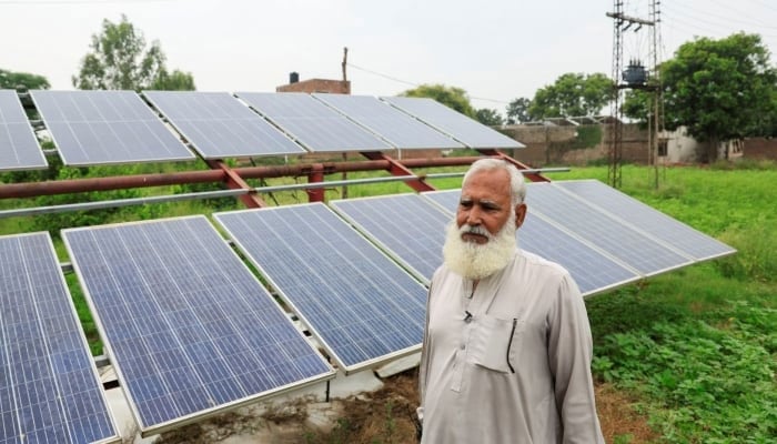 A farmer stands beside his solar panels, installed to run a tube well, in Muridke, Sheikhupura District, on August 12, 2025. — Reuters