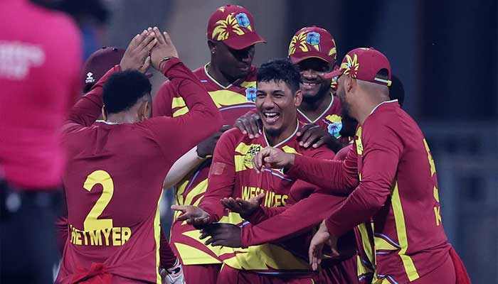 West Indies Gudakesh Motie celebrates with teammates after taking a wicket during the 2026 ICC Mens T20 Cricket World Cup group stage match between England and West Indies at the Wankhede Stadium in Mumbai on February 11, 2026. — ICC