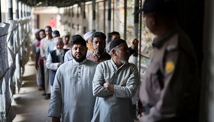 Voters stand in the queue at a polling station on the day of the 13th general election in Dhaka, Bangladesh, February 12, 2026. — AFP