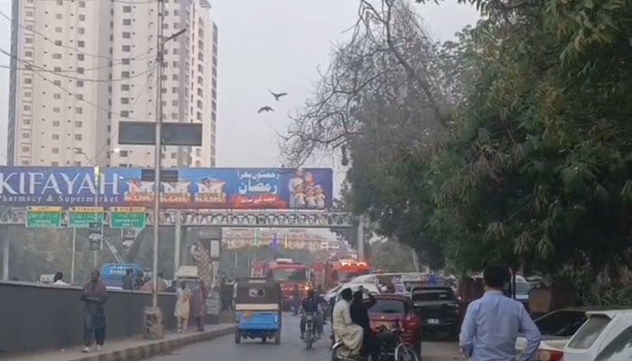 The image shows fire-tenders busy in operation to extinguish the fire in a building near the Baloch Colony bridge, in Karachi on February 12, 2026. — Geo News/File