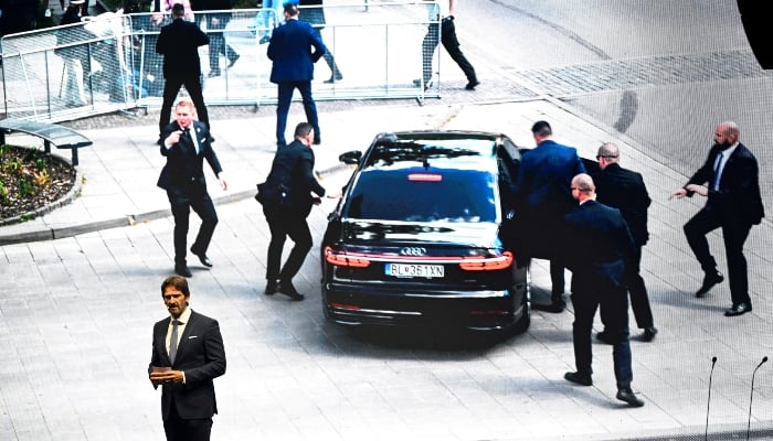 Slovak Defence Minister Robert Kalinak speaks in front of a screen displaying an image from the attempted assassination of Slovakias Prime Minister Robert Fico, during a SMER-SSD partys rally, in Handlova, central Slovakia, May 15, 2025.— Reuters