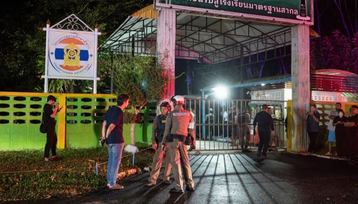 Police officers and people stand near the gate of Patongprathankiriwat School, following an incident in which a gunman entered the school and held an unknown number of students and teachers hostage, in southern Thailand’s Songkhla, Thailand, February 11, 2026. — Reuters