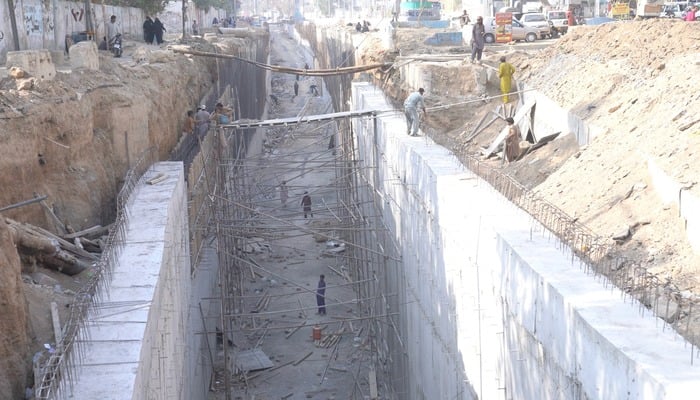 Construction work continues at the Meena Bazaar underpass in Karachis Karimabad. — Reporter