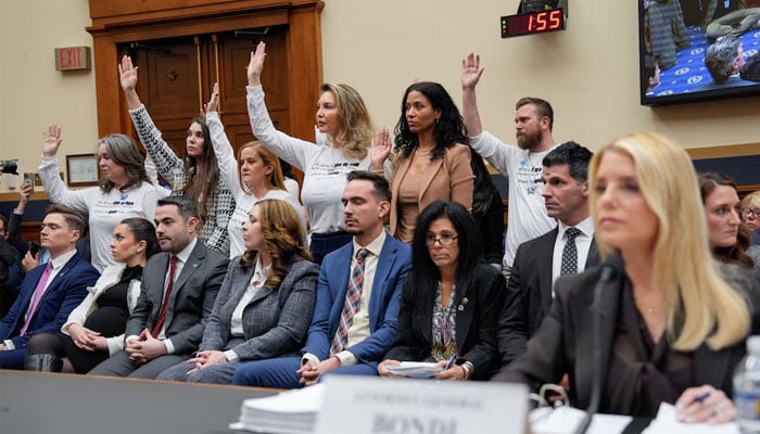 Survivors of Jeffrey Epstein raise their hands after US Representative Pramila Jayapal (D-WA) asked who of them has been unable to meet with the US Department of Justice led by Attorney General Pam Bondi, as Bondi attends a House Judiciary Committee hearing on oversight of the Justice Department to testify, on Capitol Hill in Washington. — Reuters