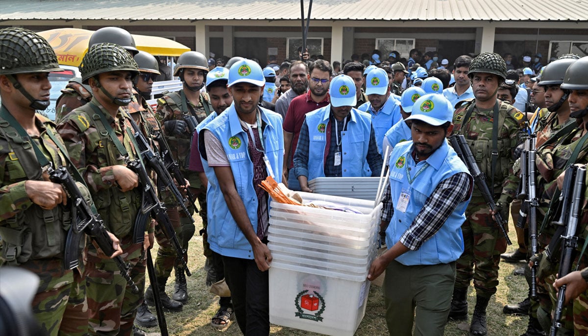 Ansar and VDP members carry ballot boxes out of a distribution center to move them to a voting centre, a day ahead of the national election in Dhaka, Bangladesh, February 11, 2026. — Reuters