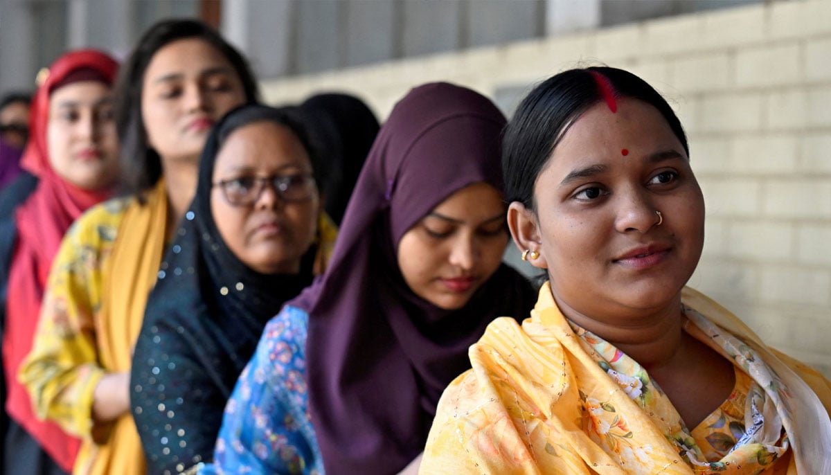 Women stand in a queue to vote outside a polling station during the national election in Dhaka, Bangladesh, February 12, 2026. — Reuters