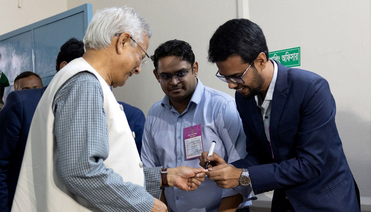 A polling officer applies ink to mark the thumb of Muhammad Yunus, Chief Advisor of the interim government of Bangladesh, as he votes inside a polling station during the national election in Dhaka, Bangladesh, February 12, 2026. — Reuters
