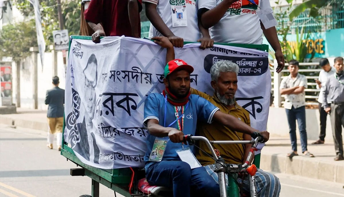 Supporters of the Bangladesh Nationalist Party (BNP) ride a vehicle outside the polling station during the 13th general election in Dhaka, Bangladesh, February 12, 2026. —AFP