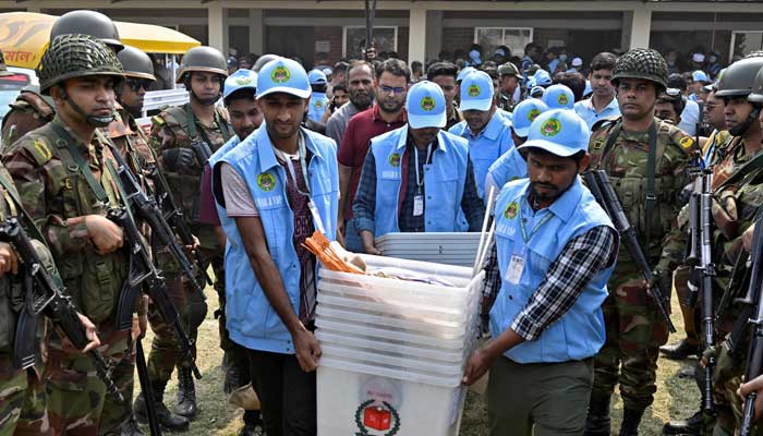 Ansar and VDP members carry ballot boxes out of a distribution center to move them to a voting centre, a day ahead of the national election in Dhaka, Bangladesh, February 11, 2026. — Reuters