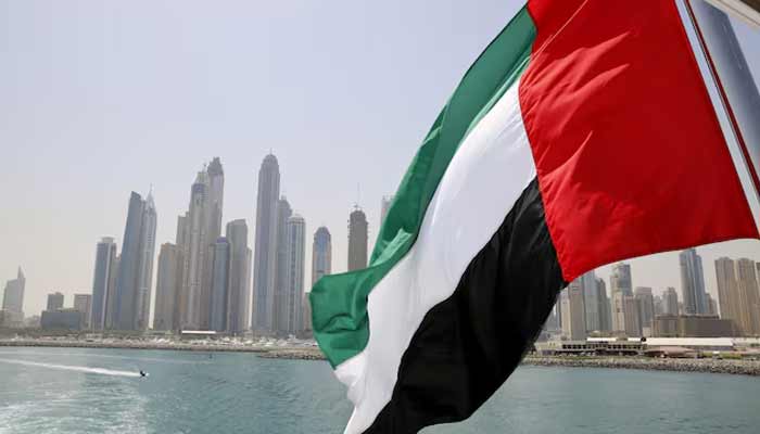 UAE flag flies over a boat at Dubai Marina, Dubai, United Arab Emirates. — Reuters