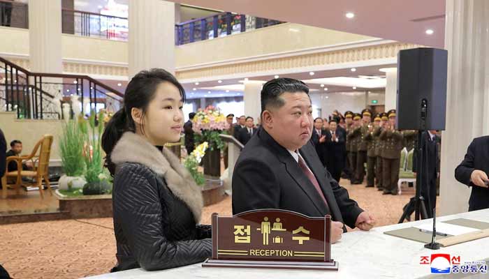 North Korean leader Kim Jong Un and his daughter Kim Ju Ae stand at a hotel reception counter as they attend an inauguration ceremony for hotels in the tourist resort in Samjiyon City, North Korea. — Reuters