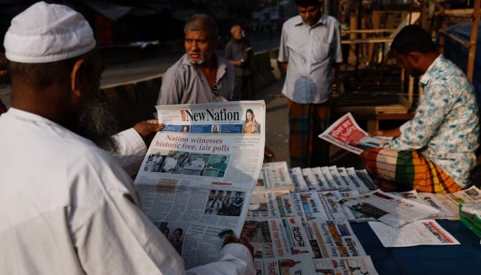 A man read an English daily newspaper at a store, the morning after the 13th general election, in Dhaka, Bangladesh, February 13, 2026. — Reuters