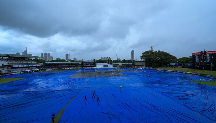 Ground staff covers the stadium amid heavy rain in Colombo, Sri Lanka, during a cricket match in this representational image. — AFP