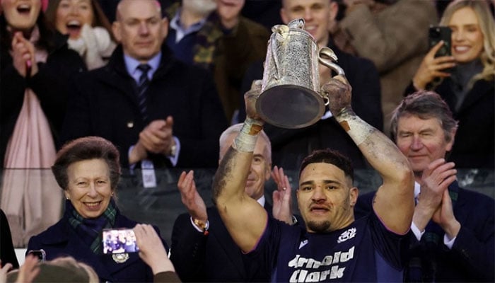 Princess Anne hugs Scotland captain after dragging husband to royal duties