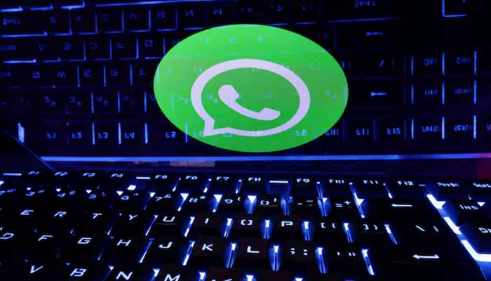 A keyboard is placed in front of a displayed WhatsApp logo. — Reuters/File