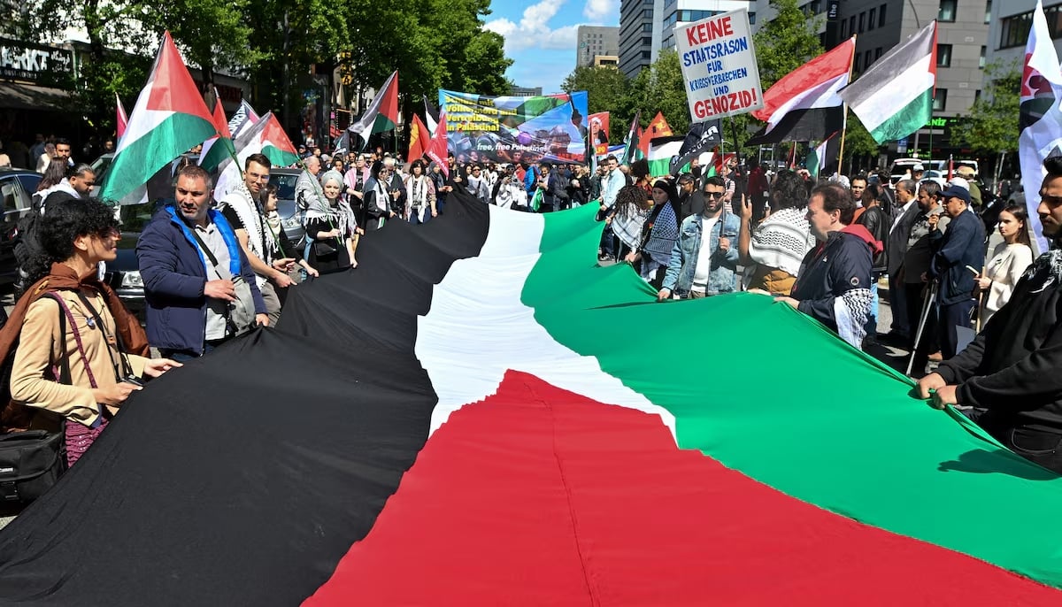 Pro-Palestinian demonstrators carry a large Palestinian flag as they protest against Israel to mark the 77th anniversary of the Nakba in Hamburg, Germany on May 17, 2025. — Reuters