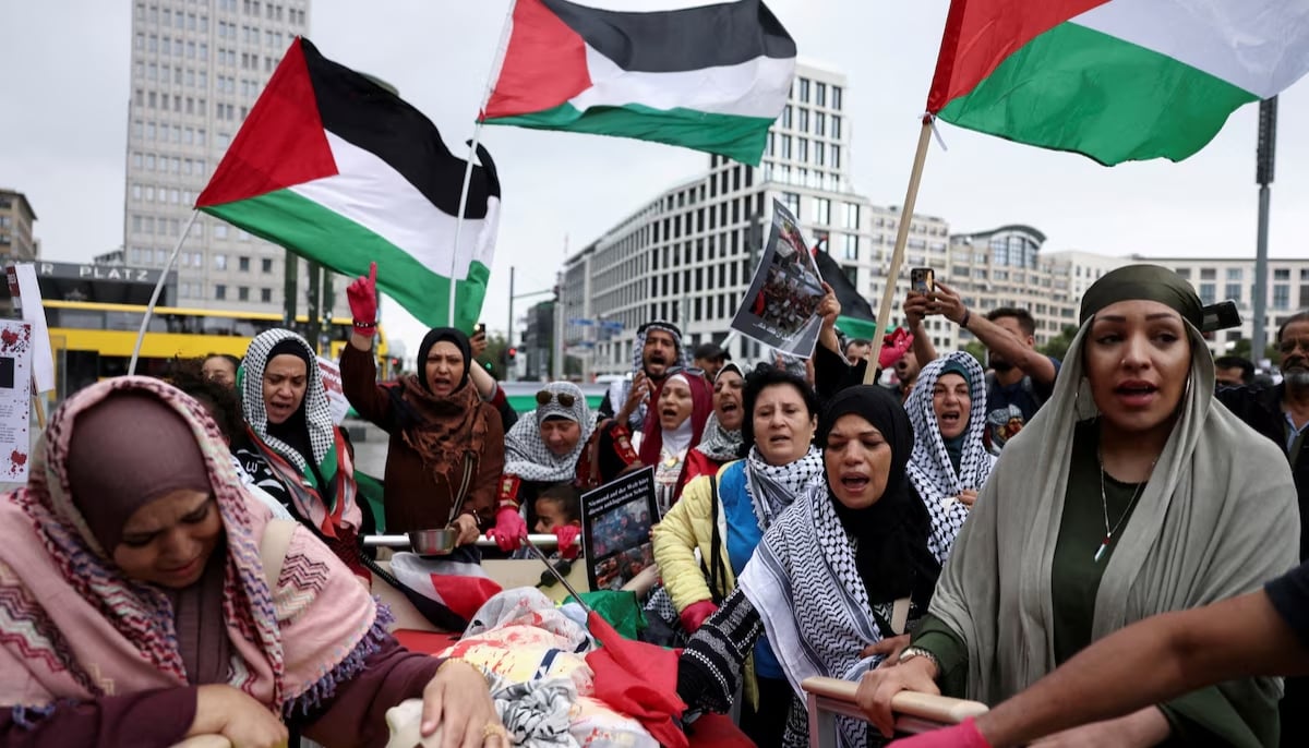 A woman mourns next to an effigy symbolising dead Palestinians as people protest against Israel and in solidarity with Palestinian children in Gaza, at Potsdamer Platz, in Berlin, Germany on August 3, 2025. — Reuters