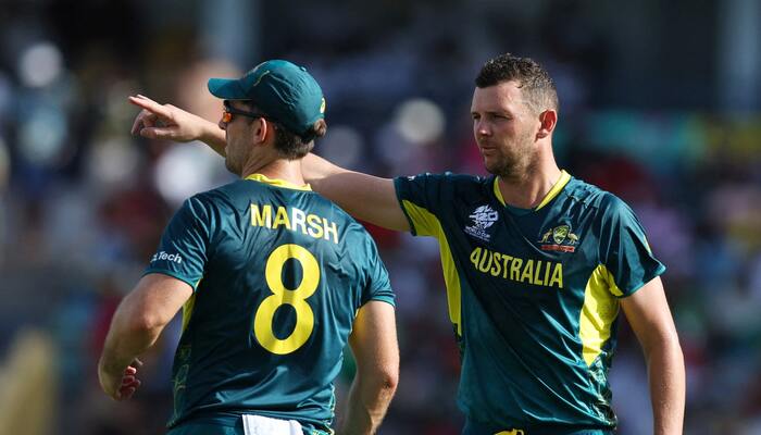 Australias Josh Hazlewood and Mitchell Marsh talks during play on June 8, 2024. — Reuters