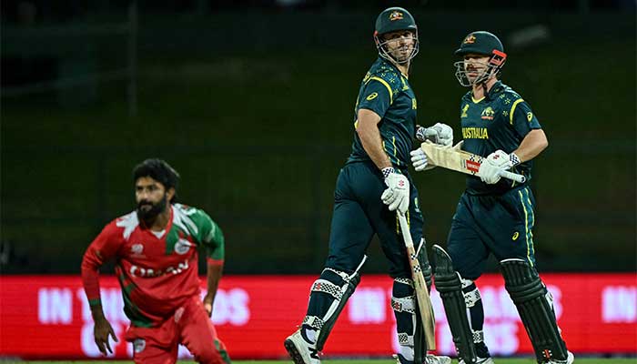 Australias Travis Head (R) and captain Mitchell Marsh (C) run between the wickets during the ICC Mens T20 Cricket World Cup 2026 group-stage match between Oman and Australia at Pallekele International Cricket Stadium in Kandy on February 20, 2026. — AFP