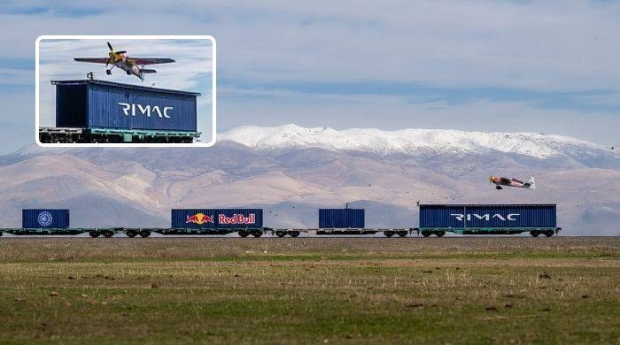 Italian pilot lands plane on moving train in daring stunt