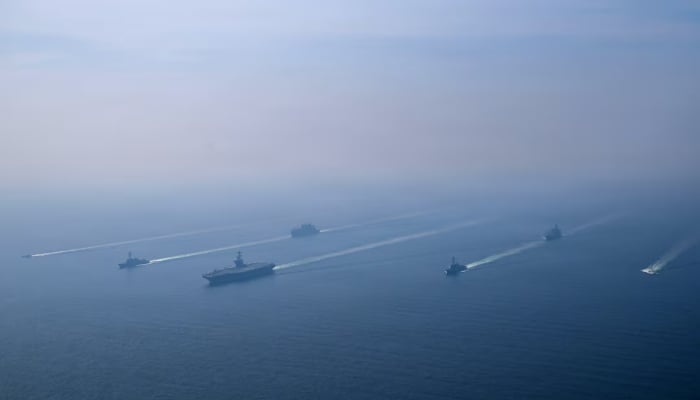 The US Navys Nimitz-class aircraft carrier USS Abraham Lincoln leads its strike group during a photo exercise in the Arabian Sea, February 6, 2026. — Reuters