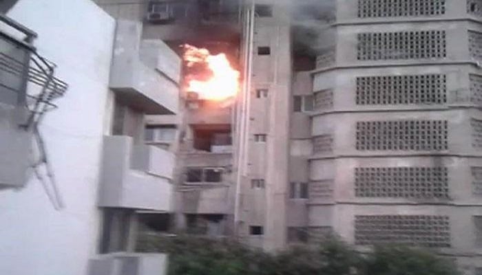 An apartment is seen on fire in Karachi in this undated screengrab. — Geo News