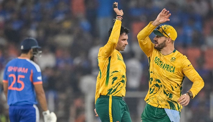 South Africas Keshav Maharaj (Centre) celebrates with captain Aiden Markram after taking the wicket of Indias Rinku Singh during the 2026 ICC Men´s T20 Cricket World Cup Super Eights match between India and South Africa at the Narendra Modi Stadium in Ahmedabad on February 22, 2026. — AFP