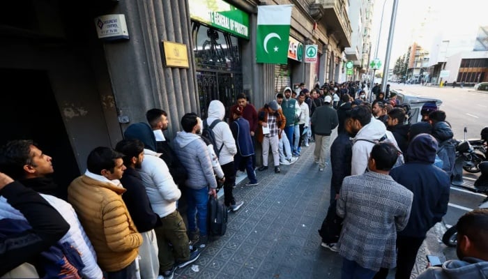 People queue outside Pakistan’s consulate in Barcelona to apply for criminal record certificates. — Reuters