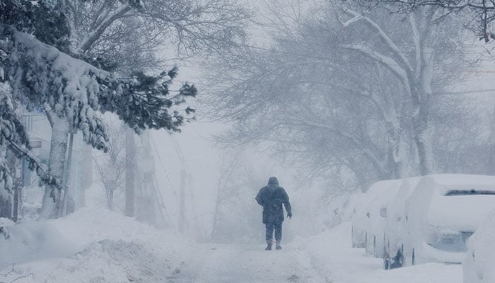 A person walks through a winter blizzard snow storm in Somerville, Massachusetts, U.S., February 23, 2026. — Reuters